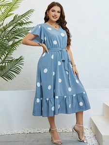 Detail of light blue V-neck polka dot dress with butterfly sleeves and a waist tie