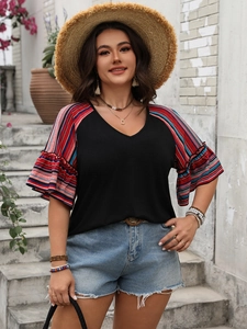 Detail of bohemian V-neck top showing colorful striped ruffle sleeves and black fabric