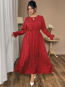 Detailed view of red polka dot maxi dress featuring tie-up neckline and ruffle cuffs