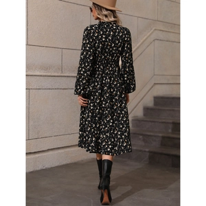Elegant long-sleeved black V-neck maxi dress with white and yellow floral patterns