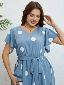 Detail of light blue V-neck dress with white polka dots and drawstring waist design