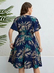 Rear view of a navy blue summer dress featuring tropical leaf print and smocked waist