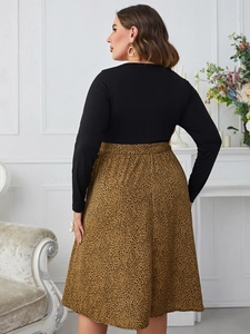 Detail of plus size dress with black long sleeve top and leopard print A-line skirt