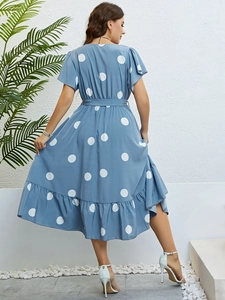 Rear view of blue polka dot summer dress showing tiered hem and ruffle sleeves