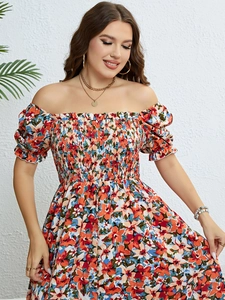 Detail of floral off-shoulder summer dress with elastic smocked bodice and puff sleeves