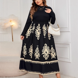 Detail view of the beige ethnic print pattern on a black high-waisted long dress