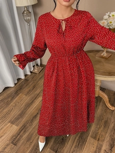 Detail of red polka dot dress with V-neckline, bow tie, and delicate elastic waist