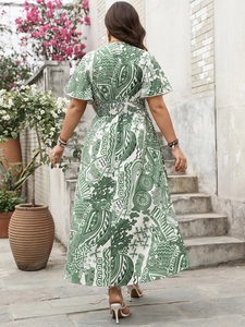 Outdoor view showing the back of an elegant high waist printed dress with flared sleeves