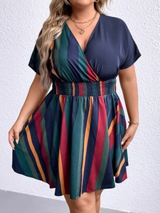 Detail of the smocked elastic waist and multicolor vertical stripes on V-neck dress