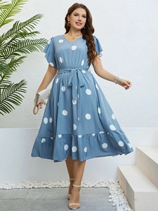 Light blue polka dot summer dress featuring a V-neckline and waist tie detail