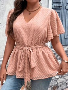 Detail of V-neck top featuring chevron texture and waist tie with butterfly sleeves