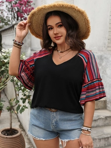 Detail of V-neck short sleeve top with colorful striped ruffle sleeves and black bodice