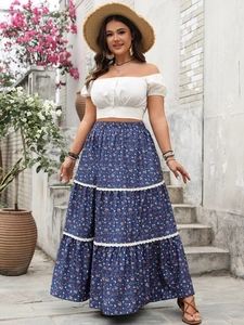 Detail of blue floral tiered maxi skirt with white lace trim and layered bohemian design