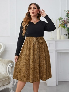Detail of loose leopard print skirt with elegant waist bow on long sleeve dress