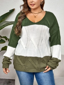Close-up of the chunky cable knit texture and color-block pattern on this warm sweater