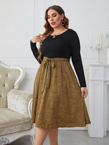 Detail of leopard print patchwork dress featuring waist tie and cutout neckline detail