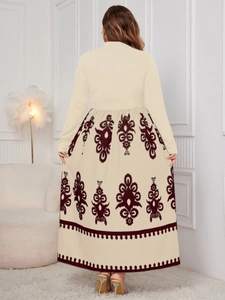 Detail of high-waist maxi dress back view featuring beige top and floral print skirt
