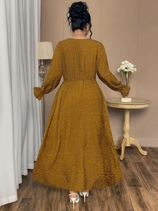 Rear view of long sleeve polka dot dress with elastic waist and ruffled cuffs details