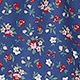 Close-up of floral print fabric with red and pink blossoms on a dark blue skirt