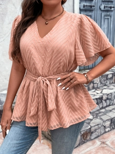 Pink V-neck blouse with chevron texture, flutter sleeves, and waist tie detail