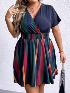Detail of V-neck wrap top and high-waisted colorful striped skirt on a plus-size dress