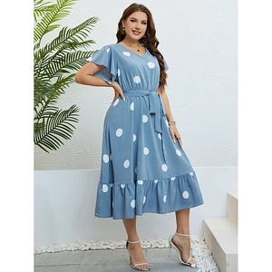 Women's light blue V-neck dress with white polka dots and a high-waisted tie belt