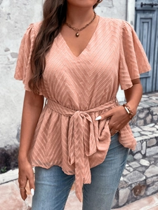 Detail of V-neck loose top featuring herringbone jacquard fabric and ruffled sleeves