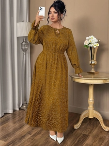 Detail of long sleeve polka dot maxi dress with high waist tie neck in ginger yellow