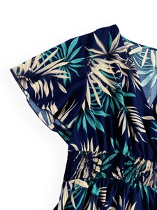 Detail of V-neck summer dress with smocking waist and tropical palm leaf print
