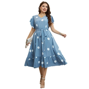 Blue V-neck wrap dress with white polka dots, ruffles, and matching waist tie belt