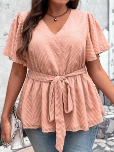 Detail of pink V-neck plus size top with ruffle sleeves and textured wave fabric