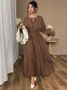 Detailed view of brown polka dot maxi dress with lantern sleeves and tie-neck design