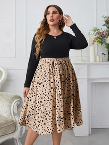 Detail of long sleeve dress featuring a leopard print skirt and waist tie bow decoration