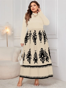 Detail of high neck long sleeve dress with black classical floral print on beige fabric