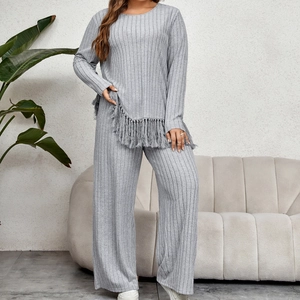 Grey knitted lounge set with asymmetric fringe top and wide-leg pants in vertical texture