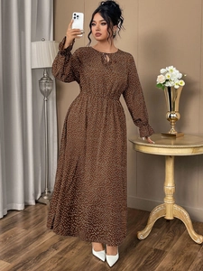 Close-up of brown polka dot maxi dress featuring waist tie and elegant long sleeves