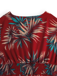 Detail of red summer dress with tropical palm leaf print and smocked waistline design