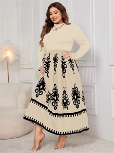 Detail of high-waisted beige dress with black tribal print and long sleeves