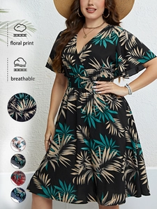 Close-up of V-neck summer dress with tropical leaf prints and breathable fabric detail