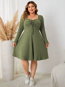 Detail of sage green knit dress with sweetheart neckline and drawstring waist tie