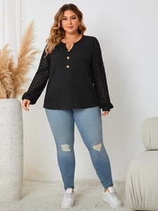 Detail of black plus size long sleeve top featuring crochet hollow out knit sleeves and buttons