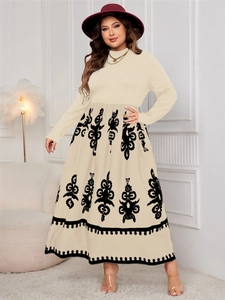Detail of high waist plus size dress with ethnic black print and long sleeves