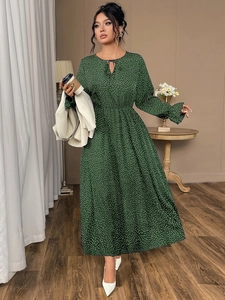 Detail of dark green polka dot maxi dress with ruffled cuffs and tie-up neck design