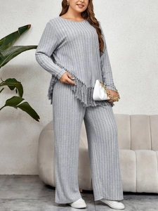 Close-up of gray ribbed knit two-piece set featuring irregular fringe hem and soft texture