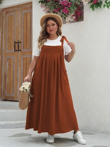 Detail of plus size caramel maxi dress featuring pleated bodice and functional side pockets