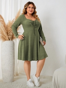 Detail of plus size olive green ribbed knit dress with heart-shaped neckline and drawstring
