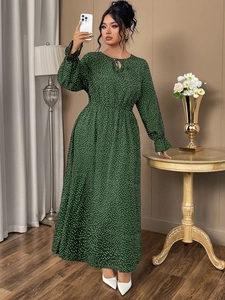 Detail of dark green polka dot maxi dress with elastic waist and ruffled long sleeves