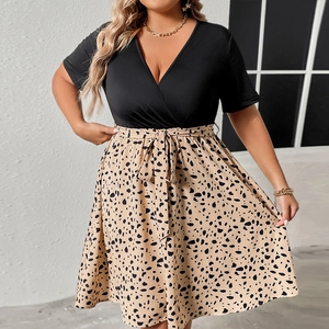 Detail of plus size V-neck dress featuring patchwork floral skirt and waist tie