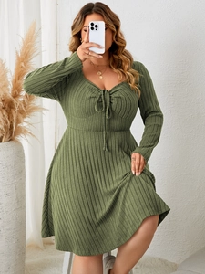Detailed texture of moss green ribbed fabric with a heart-shaped neckline and drawstring