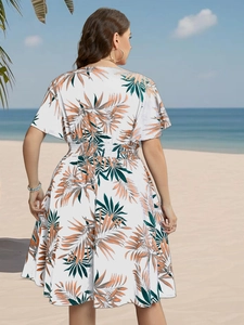 Detail of high-waist elastic waistline on a white tropical leaf print summer dress